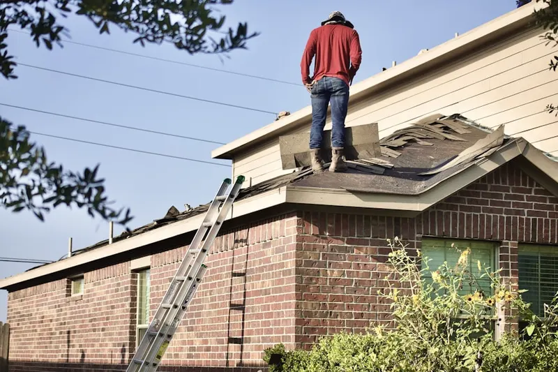 Professional roofer working on a residential roof in Villages of Oriole